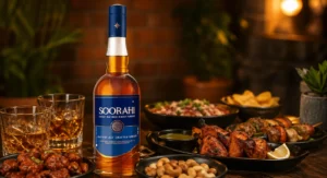 Soorahi whisky with kebabs, nuts, and drinks on a cozy dining table