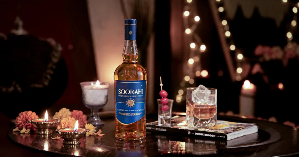 Premium whisky served with ice at a festive dinner setting